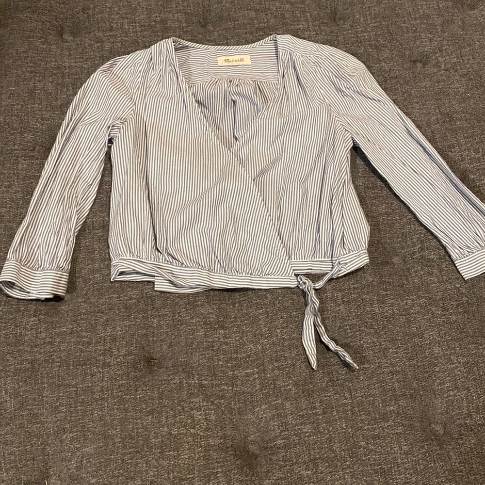 Blue and white striped blouse with bow at bottom